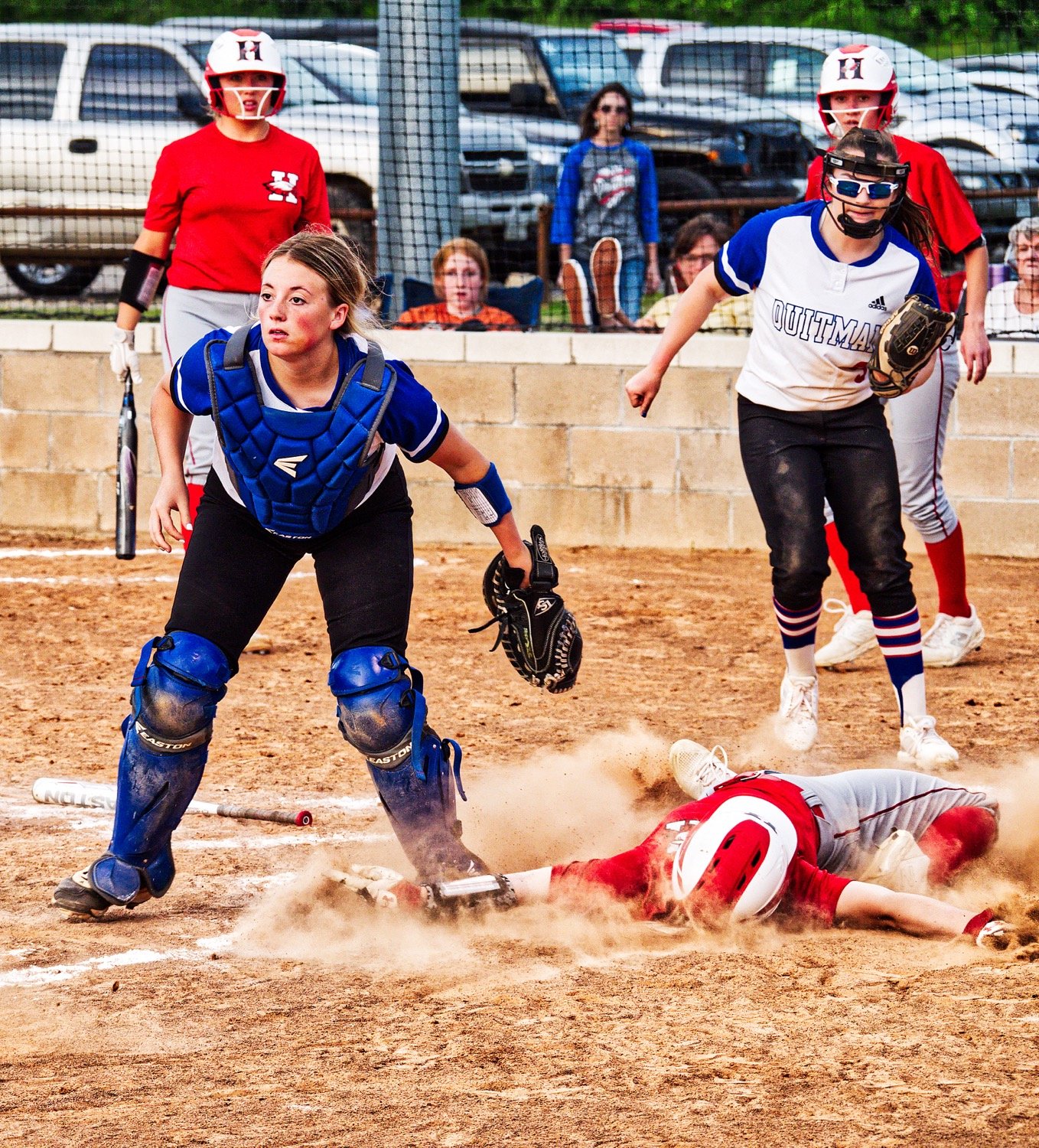 Senior catcher Kynlee Love won this battle at the plate, tagging out the Harmony base runner, as pitcher Alexis O'neal backs her up on the relay throw from senior Lindsey Hornaday. [see more senior night action]